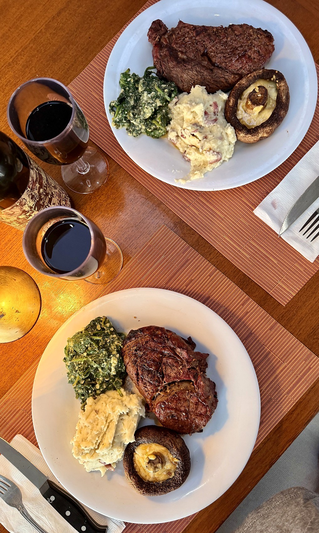 Two ribeye dinners with wine at a private table
